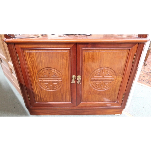 140 - A 20th century Oriental hardwood open corner cabinet with three glass shelves over pair of cabinet d... 