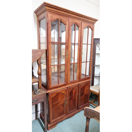 146 - A 20th century mahogany glazed display cabinet with moulded cornice over pair of glazed doors over p... 