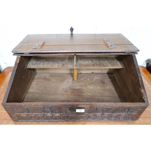 15 - An 18th century oak bible box with sloped hinged top over carved relief 