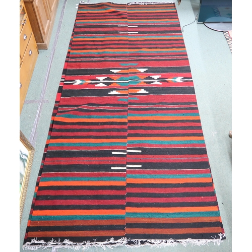 164 - An approximate pair of Zapotec Mexican rugs with geometric central medallion on multicoloured stripe... 