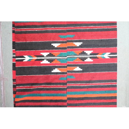 164 - An approximate pair of Zapotec Mexican rugs with geometric central medallion on multicoloured stripe... 