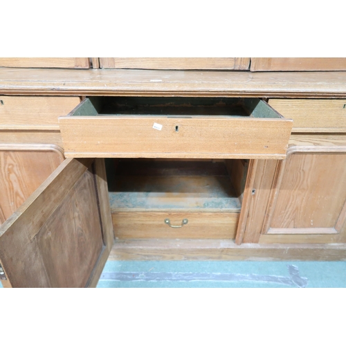 165 - A late Victorian pine library bookcase with moulded cornice over three glazed doors on base with thr... 