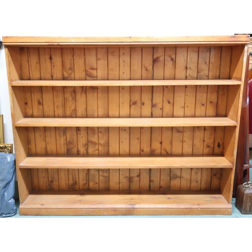 186 - A 20th century pine open bookcase, 128cm high x 156cm wide x 26cm deep