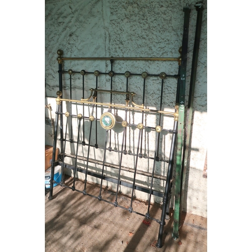 192 - A late Victorian cast iron bed frame with brass decoration, 150cm high x 120cm wide x 195cm long