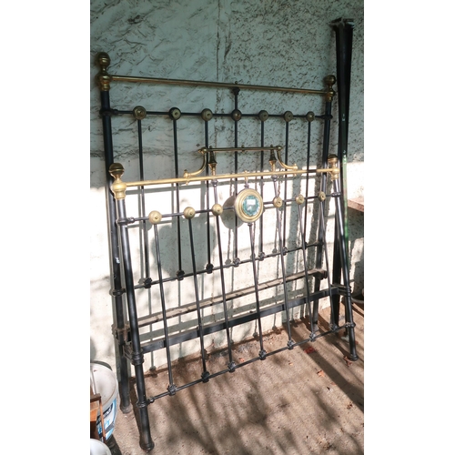 192 - A late Victorian cast iron bed frame with brass decoration, 150cm high x 120cm wide x 195cm long