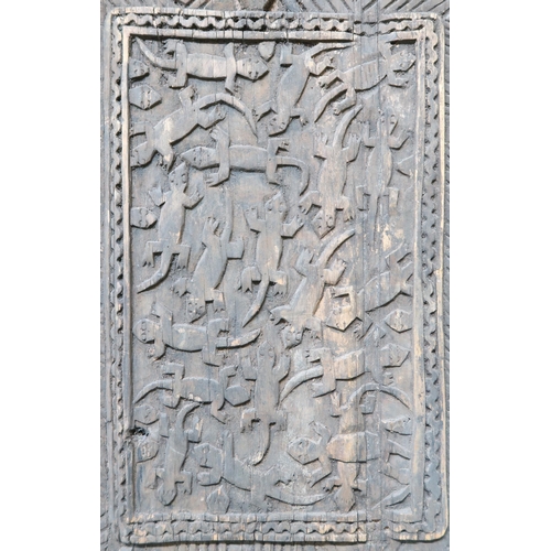 195 - A pair of west African granary doors extensively carved with reptile motifs, 159cm high x 67cm wide&... 