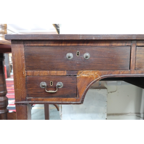 2 -  A 19th century mahogany writing desk with two long over two short drawers on square tapering s... 