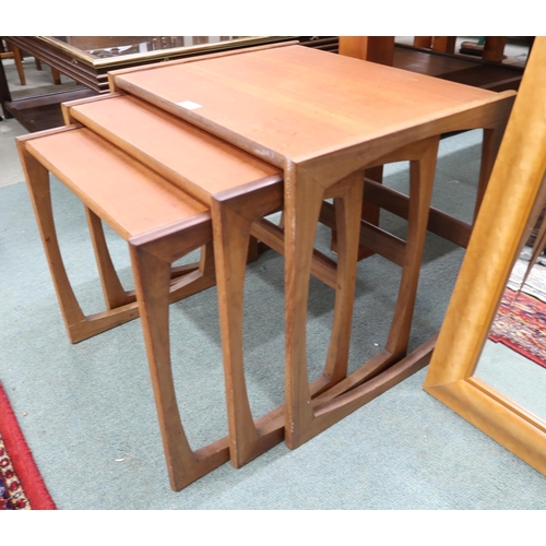 204 - A mid 20th century teak nest of three tables and a maple framed bevelled glass wall mirror (2)