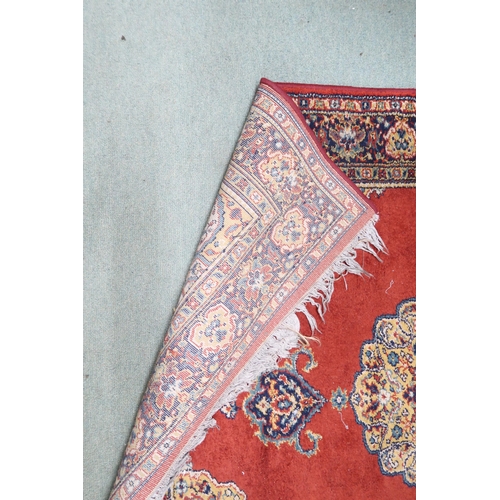 209 - A red ground Keshan style rug with beige central medallion, matching spandrels and multicoloured bor... 