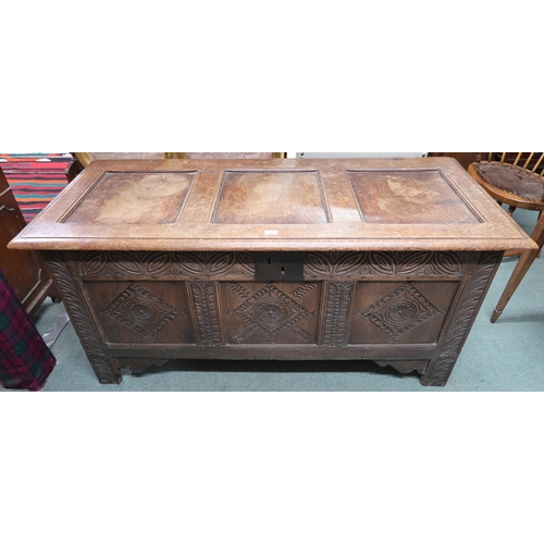 22 - An 18th century oak blanket chest with carved panel front, 71cm high x 151cm wide x 63cm deep