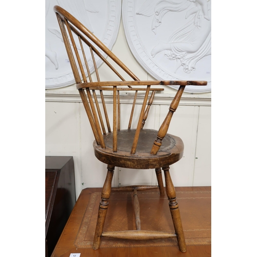 26 - A 19th century elm stick back Windsor armchair with double back over shaped seat on turned stretcher... 