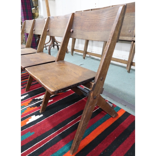 32 - A pair of early 20th century oak four seat folding pews with shaped seats, 78cm high x 187cm wide x ... 