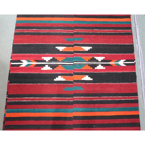 34 - An approximate pair of Zapotec Mexican rugs with geometric central medallion on multicoloured stripe... 