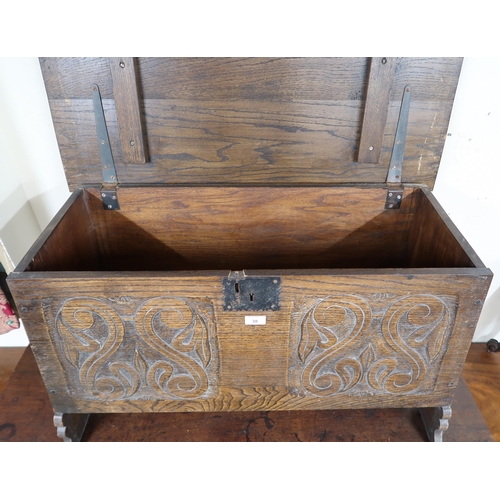 38 - A 20th century oak kist with carved front panel, 56cm high x 91cm wide x 42cm deep