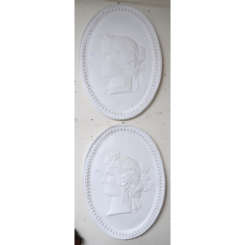 4 - A set of four oval plaster wall plaques each with cameo style silhouettes in the guise of the four s... 