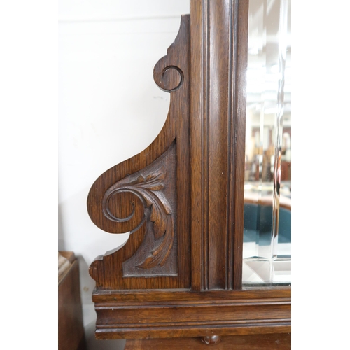 41 - A late Victorian stained oak framed bevelled glass overmantle mirror, 117cm high x 158cm wide