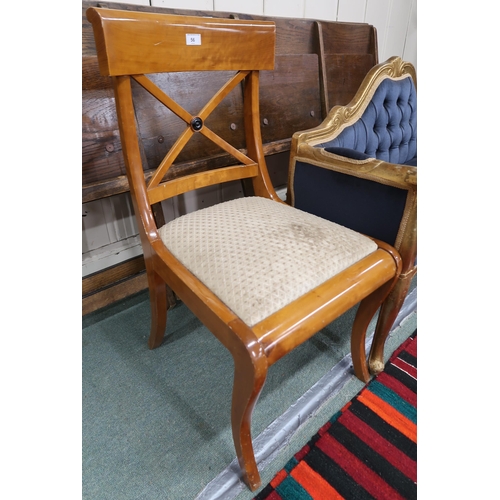 56 - A 20th century gilt framed window seat with blue button back upholstery and a sabre leg dining chair... 