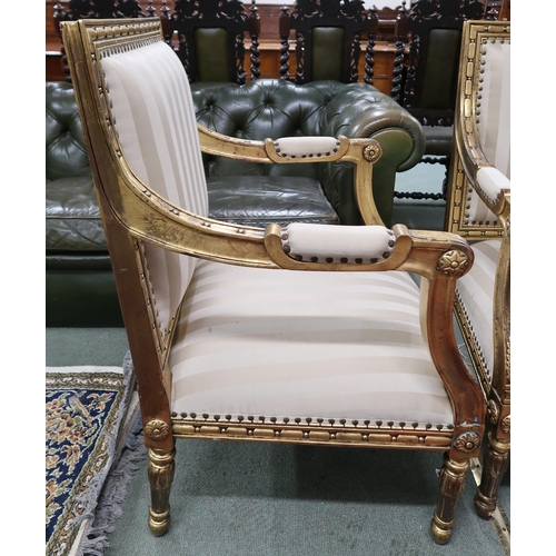 59 - A pair of 20th century gilt framed continental style open armchairs with striped upholstery, 96cm hi... 