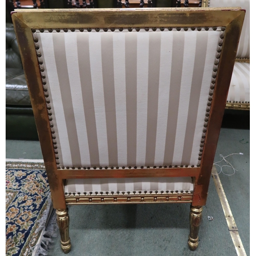 59 - A pair of 20th century gilt framed continental style open armchairs with striped upholstery, 96cm hi... 