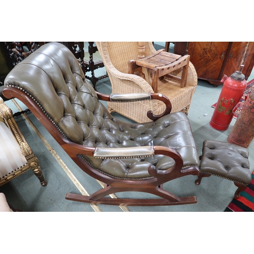 61 - A 20th century green leather button back upholstered rocking library chair and footstool