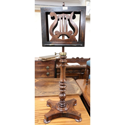 63 - A Victorian rosewood duet music stand with pierced lyre form sheet holders on turned column terminat... 