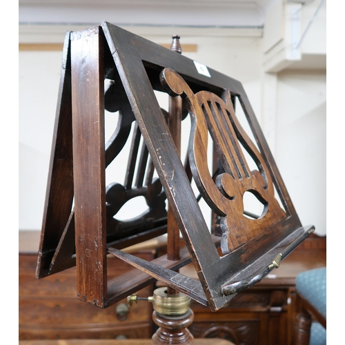 63 - A Victorian rosewood duet music stand with pierced lyre form sheet holders on turned column terminat... 