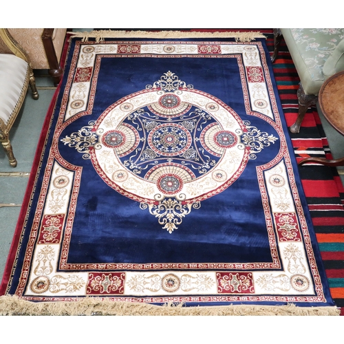 66 - A modern machine made Sarook-Kashan silk rug with cream and beige central medallion and borders on d... 