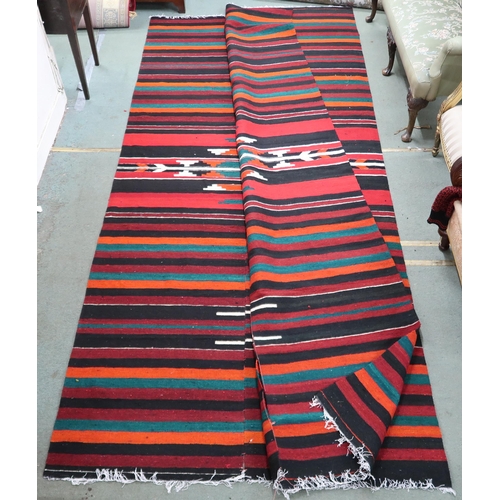 67 - An approximate pair of Zapotec Mexican rugs with geometric central medallion on multicoloured stripe... 