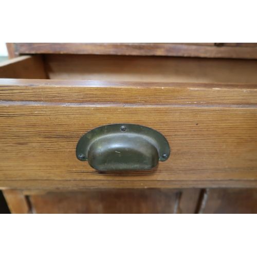 74 - A Victorian pine narrow glazed bookcase with pair of glazed doors over single drawer over pair of ca... 