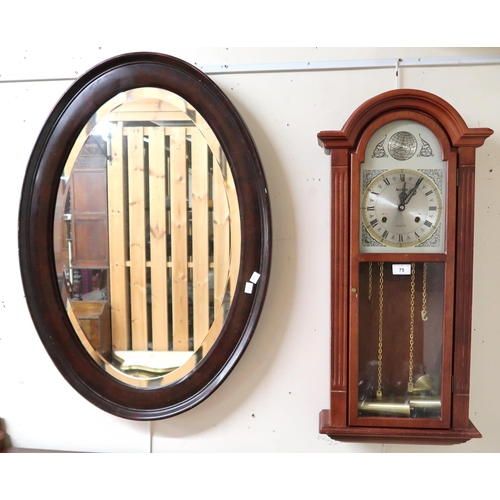 75 - A 20th century mahogany cased Tempus Fugit wall clock and an oval Victorian wall mirror (2)