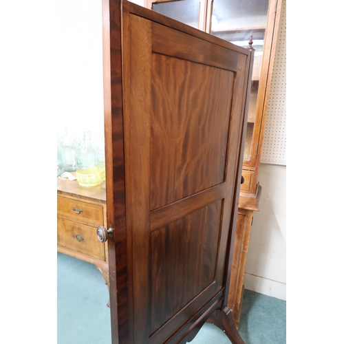 76 - A 20th century mahogany framed bevelled glass cheval mirror on out-swept supports terminating in paw... 