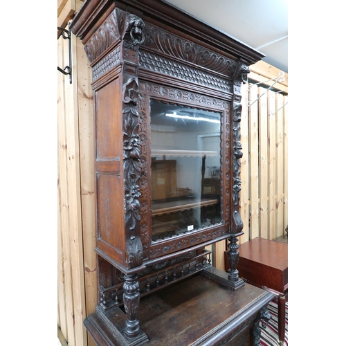 84 - A late Victorian stained oak Jacobean style hall cabinet with carved cornice bearing lion masques ov... 