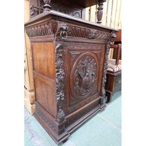 84 - A late Victorian stained oak Jacobean style hall cabinet with carved cornice bearing lion masques ov... 