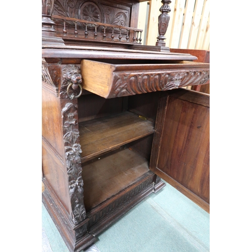 84 - A late Victorian stained oak Jacobean style hall cabinet with carved cornice bearing lion masques ov... 