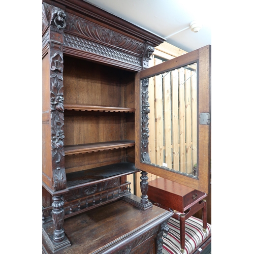 84 - A late Victorian stained oak Jacobean style hall cabinet with carved cornice bearing lion masques ov... 