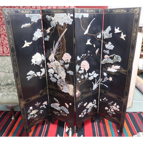 89 - A 20th century Oriental black lacquered four fold room divider with gilt painted border around stone... 