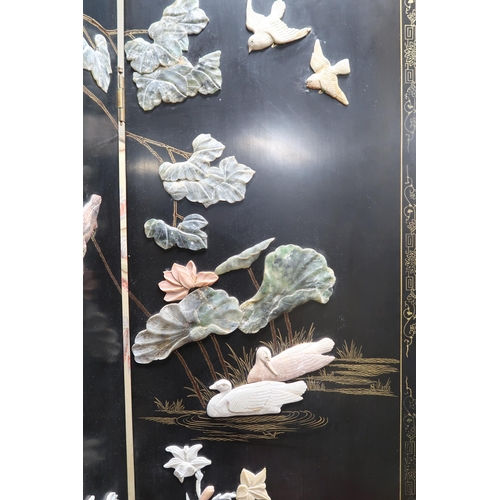 89 - A 20th century Oriental black lacquered four fold room divider with gilt painted border around stone... 