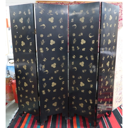 89 - A 20th century Oriental black lacquered four fold room divider with gilt painted border around stone... 