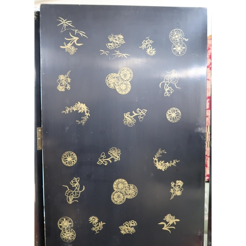 89 - A 20th century Oriental black lacquered four fold room divider with gilt painted border around stone... 