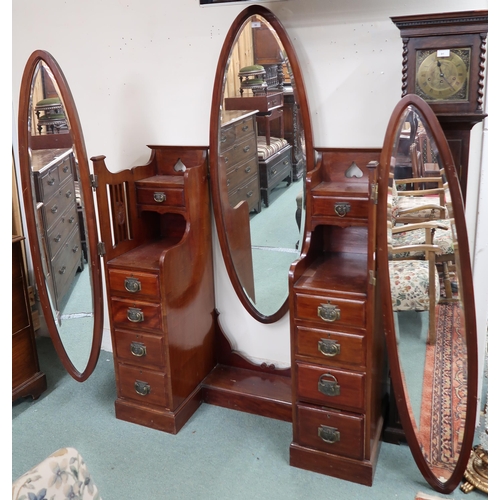 90 - An early 20th century mahogany arts and crafts dressing table with central oval dressing mirror flan... 