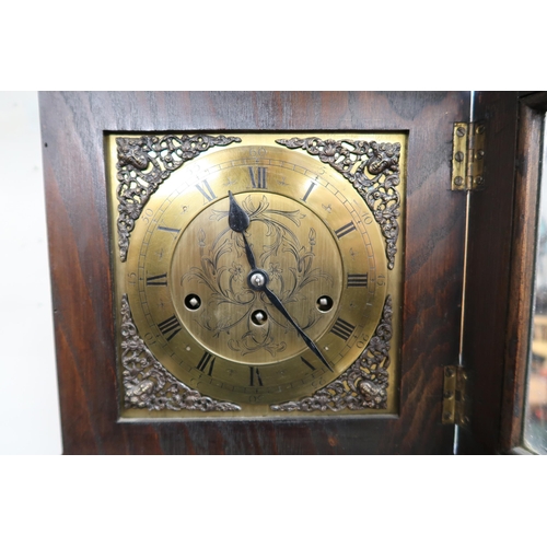 91 - A 20th century stained oak grandmother clock with brass face bearing Roman numerals, 169cm high x 35... 