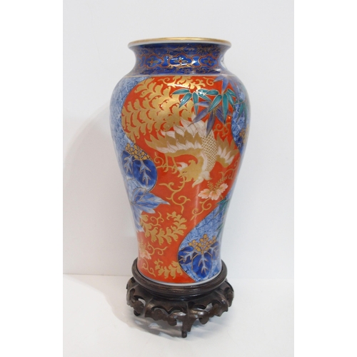 284 - An Imari porcelain vase decorated with a phoenix and bamboo, a charger, a small vase and lidded blue... 