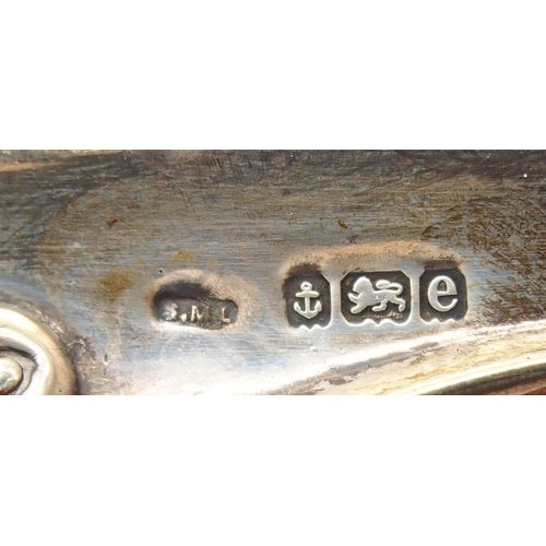 A collection of silver mounted photo frames, including a scrolling