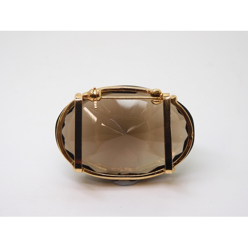 771 - A 14k gold smoky quartz ring, with similar gold plated brooch and pendant, the pendant with a 14k go... 