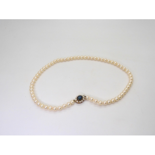 772 - A string of pearls with a 9ct gold opal doublet and pearl set clasp, length 43.5cm, pearls all appro... 