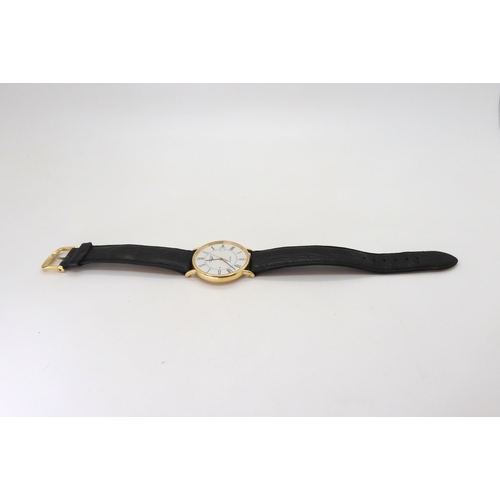 An 18k gold Longines Quartz watch with a black leather strap