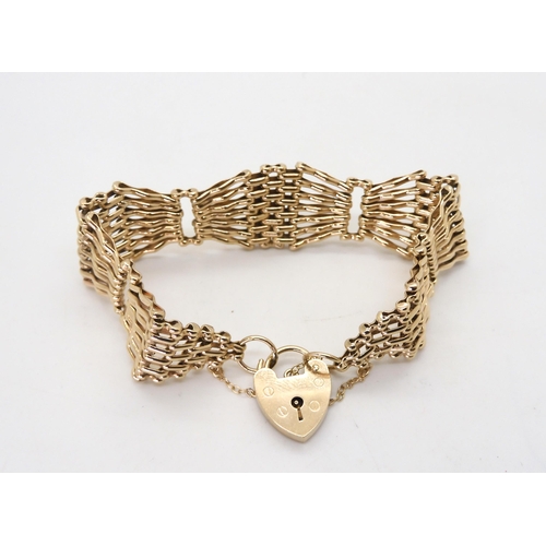 815 - A 9ct gold wide gate bracelet with heart shaped clasp, length approx 18cm, width2cm, weight 29.7gms