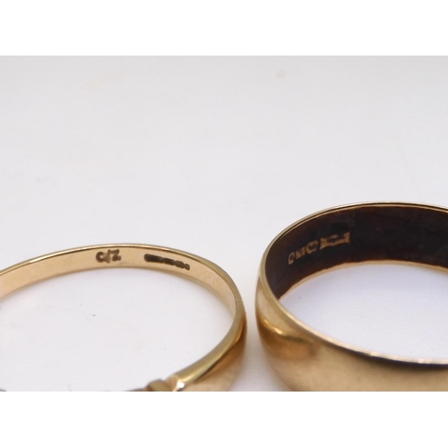 830 - A bright yellow metal wedding ring size O, 1.8gms, two 9ct gold wedding rings rose gold size L1/2, O... 