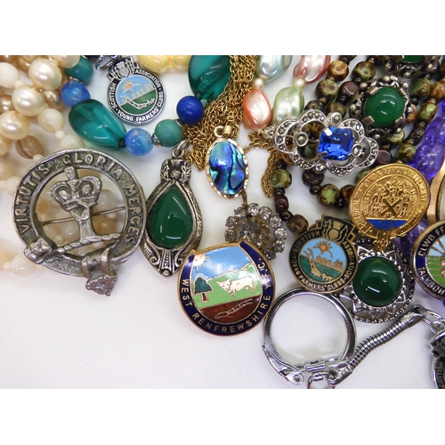 891 - A collection of vintage costume jewellery to include, items by Miracle, farming badges, beads, brooc... 