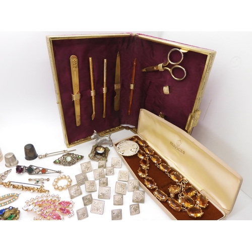 902 - Vintage perfume bottles, a gold plated manicure set, and a quantity of costume jewellery to include ... 